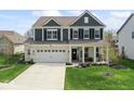 Charming two-story home with a well-manicured lawn, two car garage, and inviting front porch at 5363 Citadel Dr, Noblesville, IN 46062