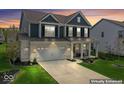 Beautiful two-story home with a well-manicured lawn, two car garage, and inviting front porch at 5363 Citadel Dr, Noblesville, IN 46062