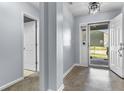 Inviting foyer with light-blue walls, decorative lighting, and an open doorway at 5465 Tanglewood Ln, Whitestown, IN 46075