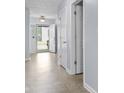 Bright entryway with neutral tile flooring, open doorway, and white trim at 5465 Tanglewood Ln, Whitestown, IN 46075