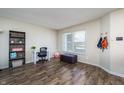 Bright office space with hardwood floors, a shelving unit, and natural light from a large window at 6209 Amber Valley Ln, Indianapolis, IN 46237
