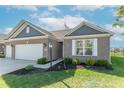 Stylish home with brick and shingle siding, well-kept landscaping, and attached two-car garage at 6229 Farlin Dr, Whitestown, IN 46075