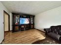 Cozy living room features wood laminate flooring, and an entertainment center at 645 Boulder Rd, Indianapolis, IN 46217