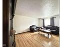 Bright living room with wood laminate flooring, neutral paint, and a comfortable seating area at 645 Boulder Rd, Indianapolis, IN 46217