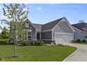 Beautiful home with well-kept lawn, gray siding, shutters and an attached garage at 6738 Fox Club Ln, Brownsburg, IN 46112