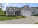 Well-maintained home with gray siding, a manicured lawn, and an attached two-car garage at 6738 Fox Club Ln, Brownsburg, IN 46112
