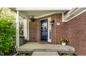 Charming front porch with brick details and a welcoming entrance, featuring flowers at 7849 Clearwater Cove Dr, Indianapolis, IN 46240