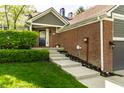 Attractive home with brick facade and landscaped walkway leading to the front door at 7849 Clearwater Cove Dr, Indianapolis, IN 46240