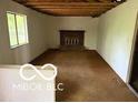 Spacious living room showcasing a brick fireplace and abundant natural light at 7916 Catawba Ct, Indianapolis, IN 46217
