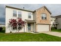 Two-story home with a brick facade, manicured lawn, and mature landscaping at 8269 S Midnight Dr, Pendleton, IN 46064