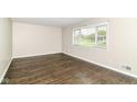 Clean bedroom with hardwood floors, neutral walls, and a window providing natural light at 8606 N Washington Blvd, Indianapolis, IN 46240