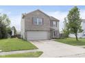 Inviting two-story home with a brick facade, a two-car garage and a well-kept lawn at 8709 Orchard Grove Ln, Camby, IN 46113