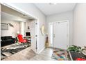 Bright entryway with a white front door, light gray walls, and stylish decor at 8811 Dorill Creek Ln, Indianapolis, IN 46259