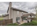 Exterior view of home highlighting the screened porch and lush backyard at 1015 Supernova Dr, Franklin, IN 46131