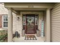 Inviting front porch with decorative wreath, welcome sign, pillars, and stylish decor at 1015 Supernova Dr, Franklin, IN 46131