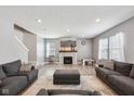 Cozy living room features a fireplace, plush seating, and large windows for ample natural light at 10358 Pronghorn Ln, Indianapolis, IN 46239