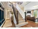 Elegant staircase with wood and wrought iron railing, leading to the upper level at 10531 Cleary Trce, Fishers, IN 46040