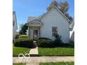 Quaint two-story house featuring a well-manicured front lawn and covered entryway at 113 1St St, Shelbyville, IN 46176