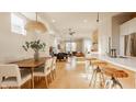 Bright, open-concept living space with hardwood floors, modern lighting, and seamless flow to the dining area at 1226 Cottage Ave, Indianapolis, IN 46203