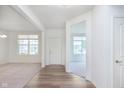 Bright foyer showcasing wood flooring and open access to the living space at 13204 Caterwood Cir, Fishers, IN 46037