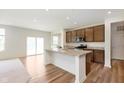 Modern kitchen features a large island with granite countertops, and sleek wooden cabinets at 13204 Caterwood Cir, Fishers, IN 46037