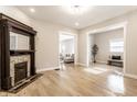 Bright living room features light wood floors, an ornate fireplace, and large openings to other rooms at 1330 Marlowe Ave, Indianapolis, IN 46202
