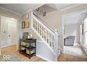Inviting foyer with staircase, console table, and views into the adjacent living space at 13363 Lantern Rd, Fishers, IN 46038