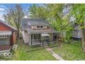 Charming home with a covered front porch and mature trees at 1529 E Gimber St, Indianapolis, IN 46203