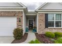 Inviting front entrance showcasing brick accents, a charming sitting area, and well-manicured landscaping at 16044 Loire Valley Dr, Fishers, IN 46037