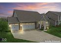 Beautiful home exterior with a three-car garage, brick accents and manicured lawn at 161 Tamarack Larch Blvd, Cicero, IN 46034