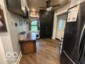 Open kitchen layout with pantry and access to the entry door at 1623 Oliver Ave, Indianapolis, IN 46221