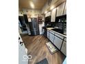 Well-lit kitchen with stainless steel appliances and stylish backsplash at 1623 Oliver Ave, Indianapolis, IN 46221