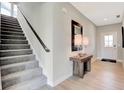 Inviting foyer with wood flooring, stairs, table with lamps, and a front door at 1713 Hemlock Cir, Greenfield, IN 46140