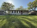 Inviting single-story home with a covered parking area and a lush green lawn, offering a welcoming facade at 1716 Arlene Dr, Indianapolis, IN 46219