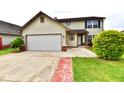 Lovely two-story home featuring an attached garage and inviting walkway at 181 Tracy Ridge Blvd, Whiteland, IN 46184