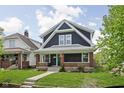 Charming two-story home featuring a classic front porch and well-maintained lawn at 1852 Singleton St, Indianapolis, IN 46203