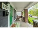 Inviting front porch with rocking chairs and brick columns at 1852 Singleton St, Indianapolis, IN 46203