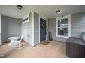 Covered front porch featuring a rocking chair, stylish accents, and ample space at 1909 Orange St, Indianapolis, IN 46203