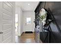 Inviting entryway featuring wood floors and elegant modern decor accents at 2242 Hemlock Cir, Greenfield, IN 46140