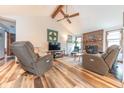 Inviting living room featuring a vaulted ceiling, wood beams, and a cozy fireplace at 3003 Foxpointe Dr, Columbus, IN 47203
