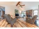 Inviting living room featuring a vaulted ceiling, wood beams, and a cozy fireplace at 3003 Foxpointe Dr, Columbus, IN 47203