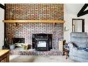 Close-up of the living room showcasing a brick fireplace with mantel, and decorative accents adding warmth at 3154 E German E Rd, Shelbyville, IN 46176