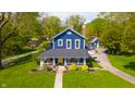 Beautifully maintained two-story home with lush landscaping, long driveway, and charming guest house at 3405 W 8Th Street Rd, Anderson, IN 46011