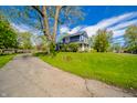 Charming two-story home with a welcoming front porch and a large, well-maintained front yard at 3405 W 8Th Street Rd, Anderson, IN 46011