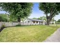 Charming home with well-kept lawn, white picket fence, and mature trees in a residential neighborhood at 3864 Esquire Ct, Indianapolis, IN 46226