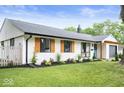 Well-maintained single-story home featuring updated black trim, wooden shutters, and landscaped yard at 3864 Esquire Ct, Indianapolis, IN 46226