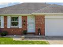 Close-up of the front entry, highlighting the brick facade, white trim, and well-kept garden bed at 389 Vinewood N Dr, Brownsburg, IN 46112