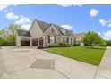 Attractive home with a long driveway, three-car garage and well-kept front lawn and landscaping at 3965 Andretti Dr, Zionsville, IN 46077