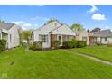 Well-maintained home with a green lawn and manicured hedges enhancing its curb appeal at 46 N Kitley Ave, Indianapolis, IN 46219