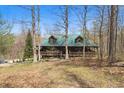 Cozy log cabin with a metal roof surrounded by trees, offering a secluded and peaceful retreat at 4840 N Templin Rd, Martinsville, IN 46151